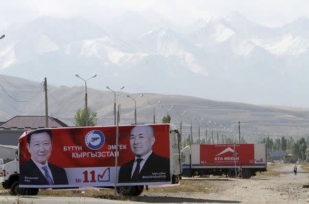 Election campaign posters are attached to trucks on the outskirts of the capital Bishkek, Kyrgyzstan, October 1, 2015. REUTERS/Vladimir Pirogov