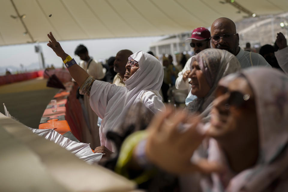 Muslim pilgrims cast stones at pillars in the symbolic stoning of the devil, the last rite of the annual hajj, in Mina, near the holy city of Mecca, Saudi Arabia, Tuesday, June 18, 2024. Muslim pilgrims were wrapping up the Hajj pilgrimage in the deadly summer heat on Tuesday with the third day of the symbolic stoning of the devil, and the farewell circling around Kaaba in Mecca's Grand Mosque. (AP Photo/Rafiq Maqbool)