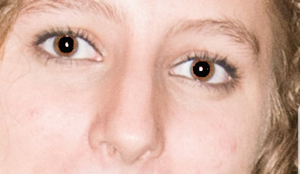 A close-up photo of eyes with the the red from the flash being covered by black with photo shop