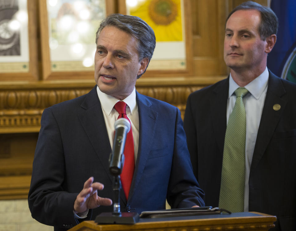 Kansas Gov. Jeff Colyer, along with his running mate Tracey Mann, talk to reporters in Topeka, Kan., Wednesday, Aug. 8, 2018, a day after his primary race against Kansas Secretary of State Kris Kobach. (Travis Heying/The Wichita Eagle via AP)