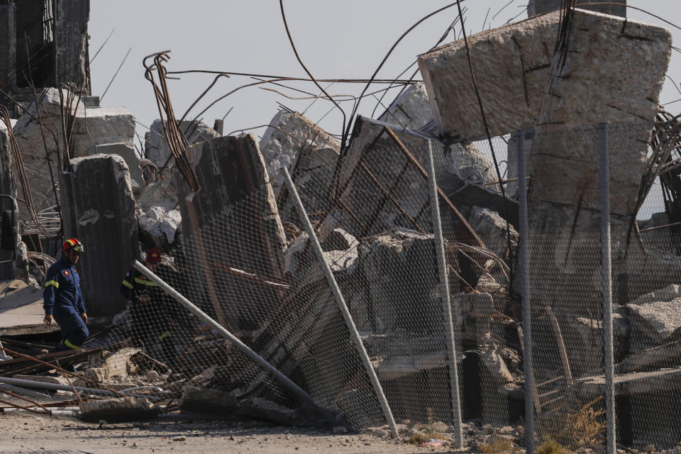 A firefighters searches for trapped people at a damaged structure following an earthquake at the port of Piraeus, near Athens, on Friday, July 19, 2019. The Athens Institute of Geodynamics gave the earthquake a preliminary magnitude of 5.1 but the U.S. Geological Survey gave it a preliminary magnitude of 5.3. The Athens Institute says the quake struck at 2:38 p.m. local time (1113 GMT) about 26 kilometers (13.7 miles) north of Athens. (AP Photo/Petros Giannakouris)