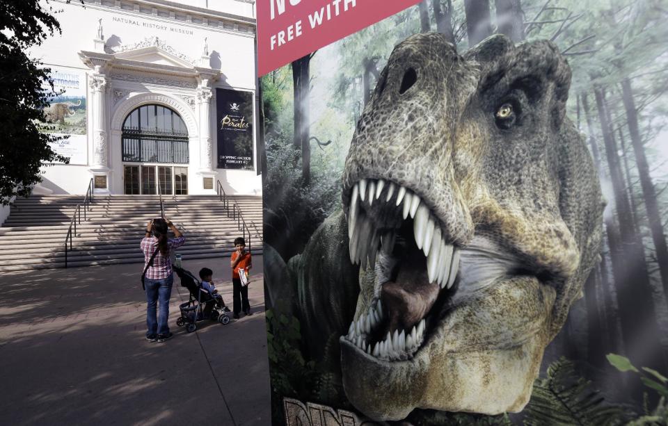 In this Oct. 2, 2013, a family strolls past the Natural History Museum in Balboa Park in San Diego. Balboa Park will be marking its 100th anniversary in 2015 with a host of festivities, although any day is worth a visit to the 1,200-acre urban oasis that rivals New York’s Central Park and is home to the San Diego Zoo. (AP Photo/Gregory Bull)