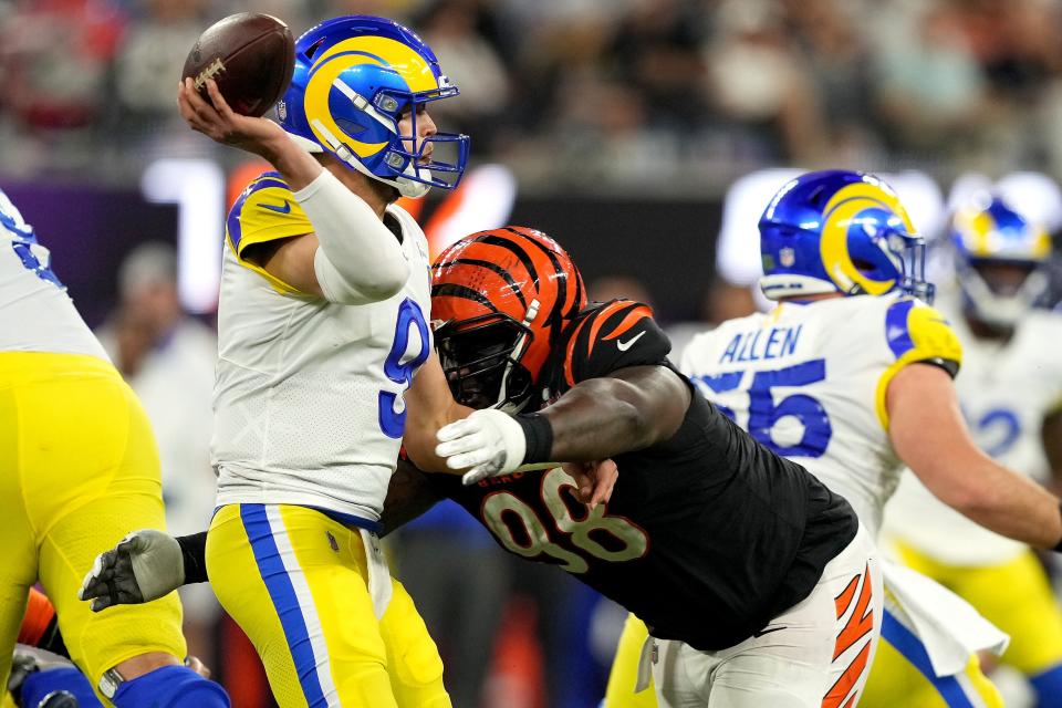 Los Angeles Rams quarterback <a class="link " href="https://sports.yahoo.com/nfl/players/9265/" data-i13n="sec:content-canvas;subsec:anchor_text;elm:context_link" data-ylk="slk:Matthew Stafford;sec:content-canvas;subsec:anchor_text;elm:context_link;itc:0">Matthew Stafford</a> (9) is hit as he throws by Cincinnati Bengals nose tackle D.J. Reader (98) in the third quarter during Super Bowl 56, Sunday, Feb. 13, 2022, at SoFi Stadium in Inglewood, Calif. The Cincinnati Bengals lost, 23-20.