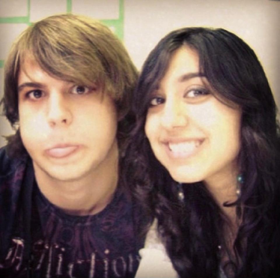 A boy and a girl pose for a selfie.