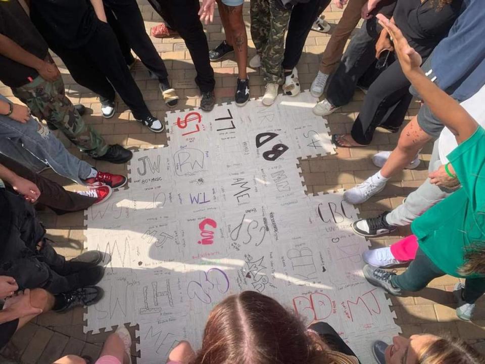 Students stand around customized foam tiles at Charlotte’s Emerald School of Excellence, a recovery high school for those struggling with substance abuse or other disorders.