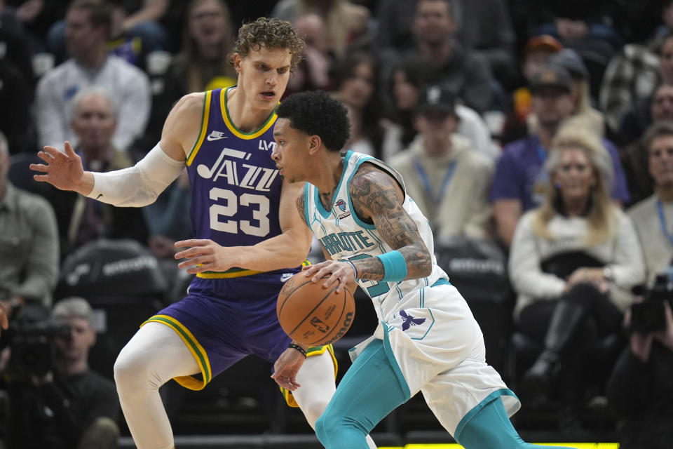 Utah Jazz forward Lauri Markkanen (23) defends against Charlotte Hornets guard Tre Mann during the first half of an NBA basketball game Thursday, Feb. 22, 2024, in Salt Lake City. (AP Photo/Rick Bowmer)