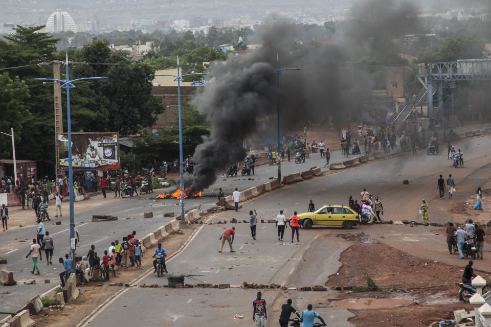 Anti-government protesters burn tires and barricade roads in the capital Bamako, Mali Friday, July 10, 2020. Thousands marched Friday in Mali's capital in anti-government demonstrations urged by an opposition group that rejects the president's promises of reforms. (AP Photo/Baba Ahmed)