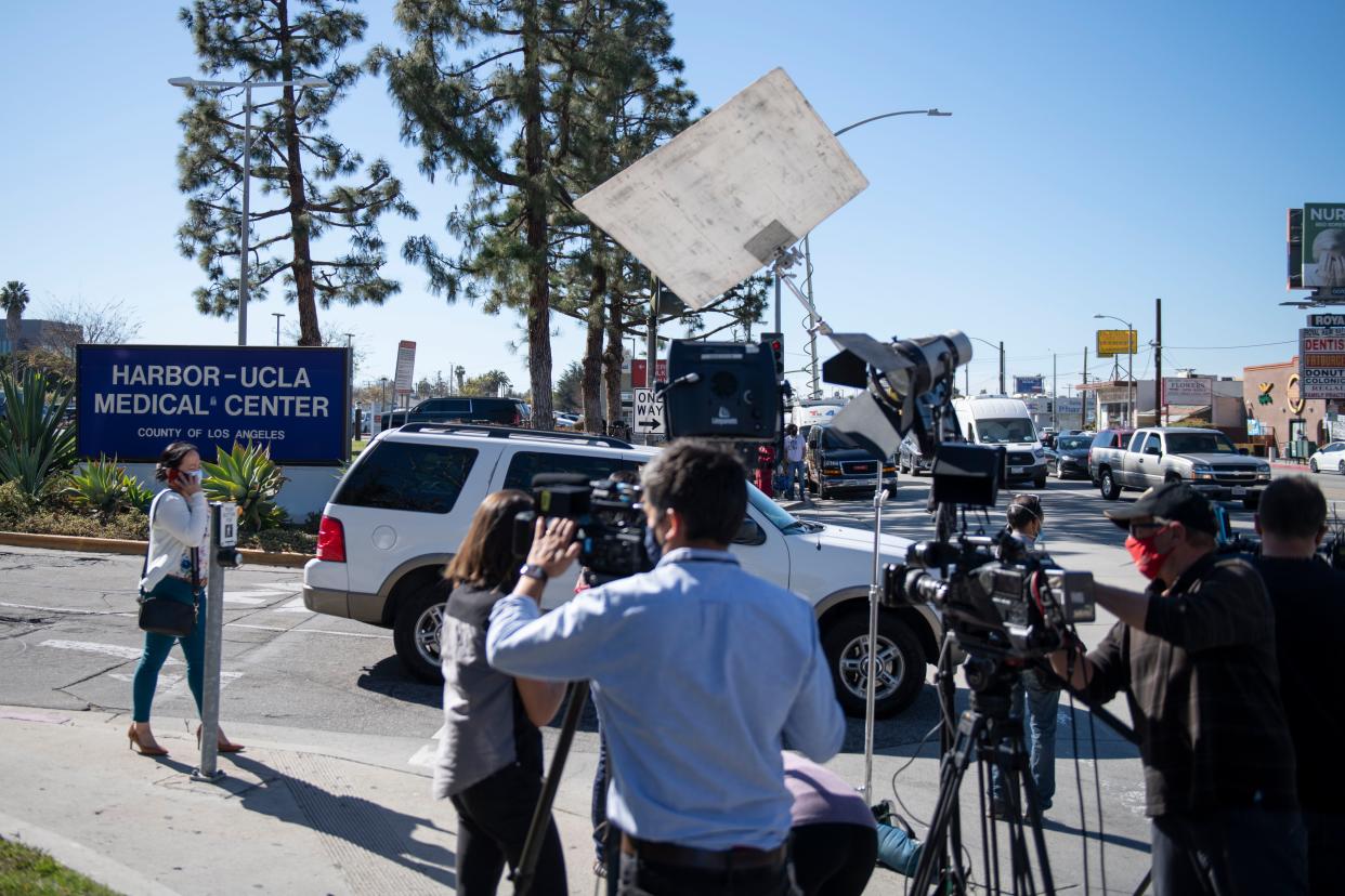 Members of the media gather outside an entrance to Harbor-UCLA Medical Center, Tuesday, Feb. 23, 2021, in Torrance, Calif., where golfer Tiger Woods was hospitalized there following a car accident.
