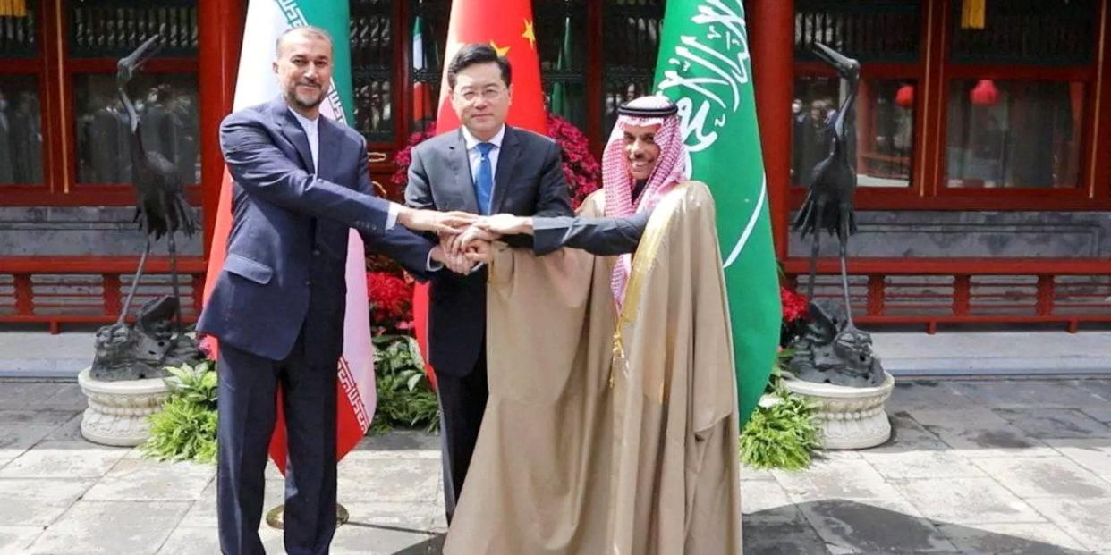 Iranian Foreign Minister Hossein Amir-Abdollahian and Saudi Arabia's Foreign Minister Prince Faisal bin Farhan Al Saud and Chinese Foreign Minister Qin Gang shake hands during a meeting in Beijing, China, April 6, 2023