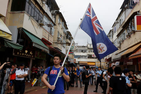 A local protester against mainland Chinese parallel traders carries a British Hong Kong colonial flag in Hong Kong, China, May 1, 2016. REUTERS/Bobby Yip