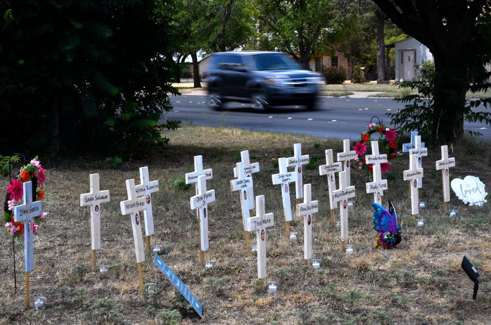 Crosses memorializing the victims of the May 24 shooting at Uvalde's Robb Elementary School are on display in a east-side yard in the 1500  block of Grape Street.
