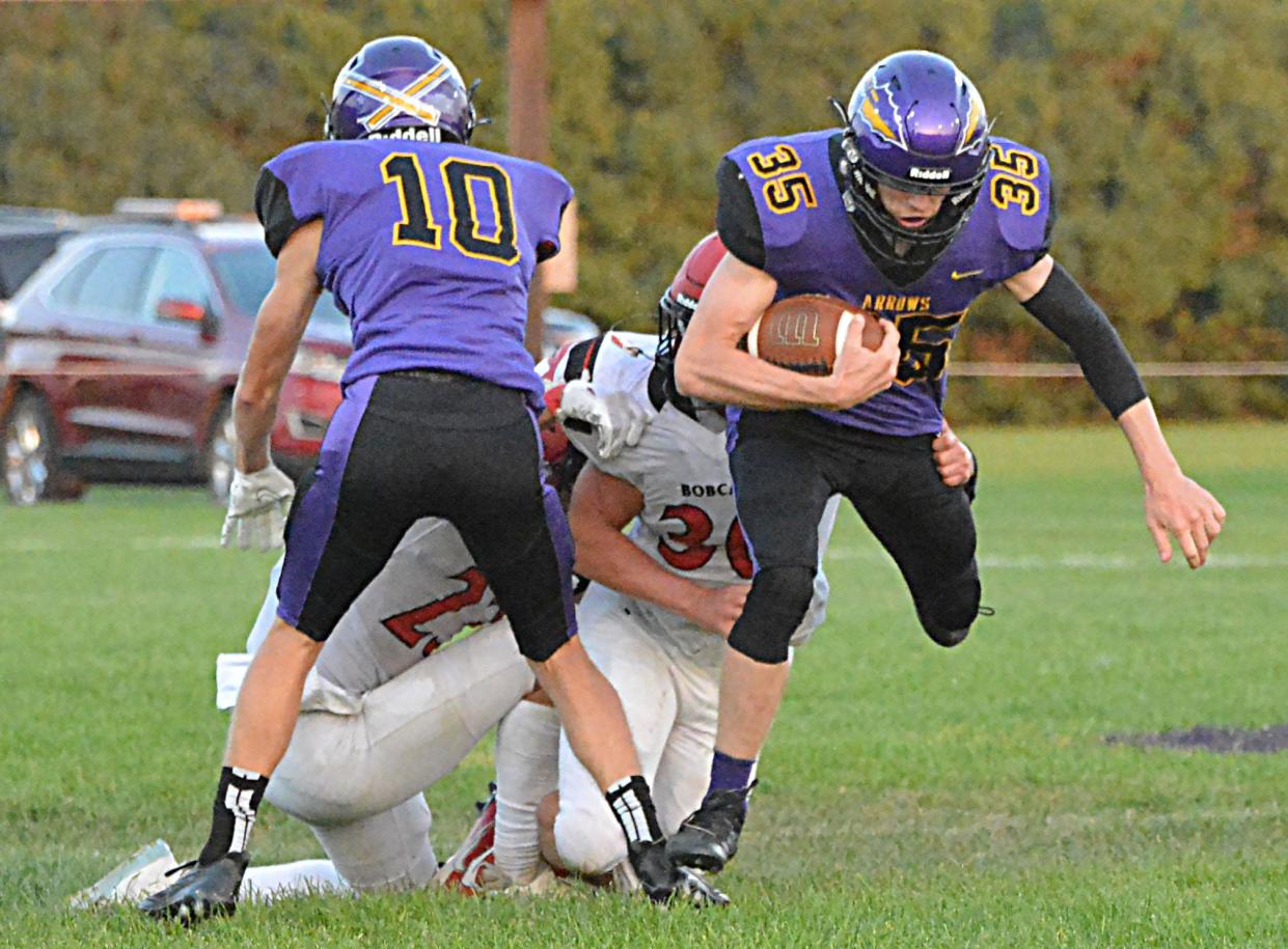 Watertown's Owen Spartz tries to escape from a Brookings defender with the help of teammate Kohen Kranz (10) during their season-opening Eastern South Dakota Conference football game on Friday, Aug. 25, 2023 at Watertown Stadium.