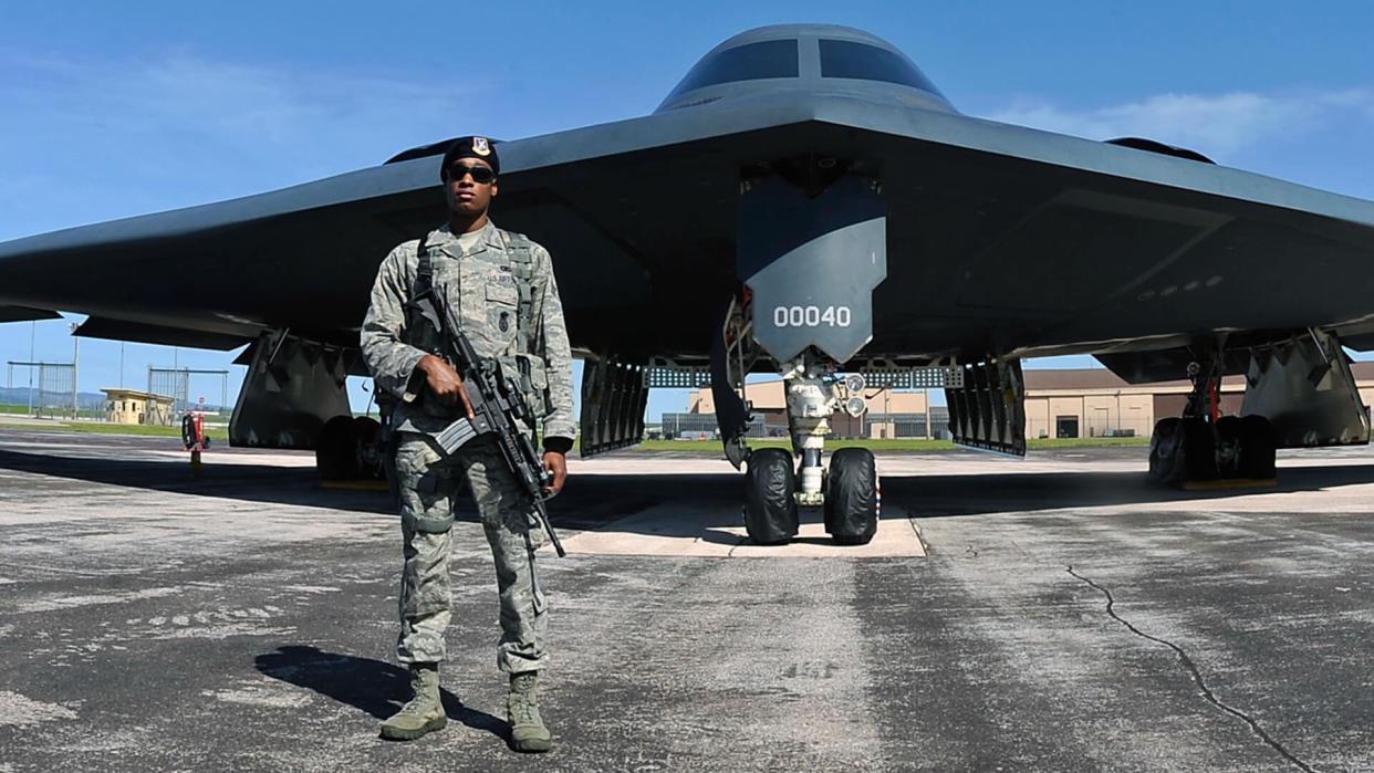 An Airman assigned to the 28th Security Forces Squadron guards of a B-2 Spirit during the 2011 Dakota Thunder airshow at Ellsworth Air Force Base, S.