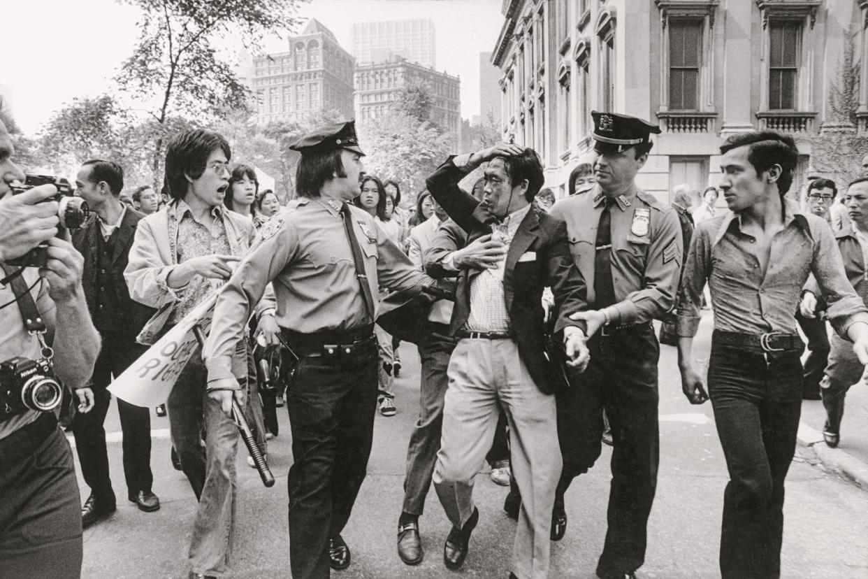 A protester bleeds after an altercation with police (The Estate of Corky Lee)