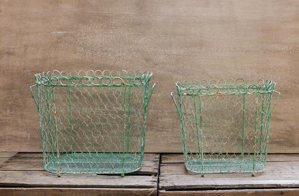 In this photo provided by Farmhouse Wares, turquoise wire baskets like these have a French garden vibe that’s on trend this spring and summer. Use them for storing everything from pet gear to laundry supplies to magazines and books. (AP Photo/FarmhouseWares)