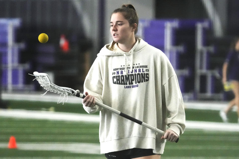 Northwestern's Izzy Scane plays with a ball while warming up for practice in Evanston, Ill., Tuesday, Feb. 6, 2024. (AP Photo/Nam Y. Huh)