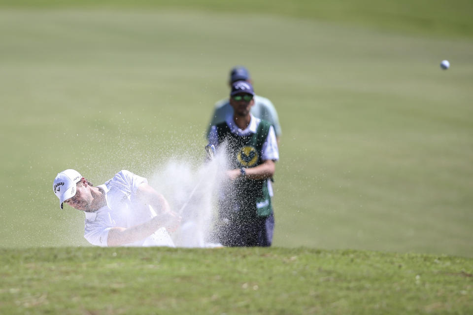 Thomas Detry, of Belgium, takes a shot out of the bunker alongside the ninth fairway during the second round of the Sanderson Farms Championship golf tournament in Jackson, Miss., Friday, Sept. 30, 2022. (James Pugh/impact601.com via AP)