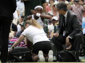 United States' Cori "Coco" Gauff receives medical assistance during a women's singles match against Romania's Simona Halep on day seven of the Wimbledon Tennis Championships in London, Monday, July 8, 2019. (AP Photo/Kirsty Wigglesworth)