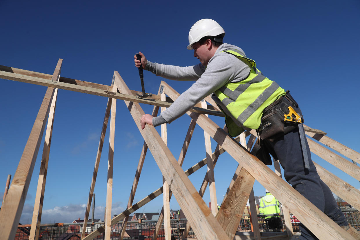 A builder working for Taylor Wimpey builds a roof on an estate in Aylesbury, Britain, February 7, 2017.  REUTERS/Eddie Keogh
