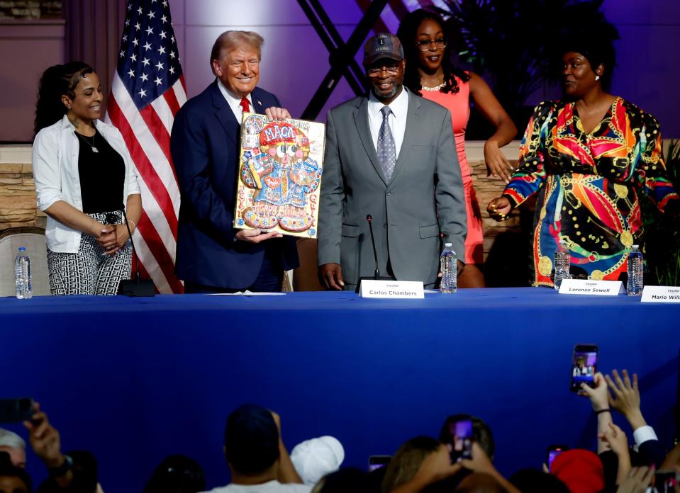 Former President Donald Trump shows off the decorated birthday cake cookie that was given to him after the crowd sang happy birthday to him following the roundtable discussion inside the 180 Church in Detroit on Saturday, June 15, 2024.