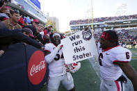 Georgia offensive lineman Justin Shaffer (54) and running back Kenny McIntosh (6) celebrate after defeating Georgia Tech in an NCAA college football game Saturday, Nov. 27, 2021, in Atlanta. (AP Photo/John Bazemore)