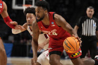 Maryland forward Donta Scott (24) dribbles past Alabama guard Mark Sears (1) in the first half of a second-round college basketball game in the NCAA Tournament in Birmingham, Ala., Saturday, March 18, 2023. (AP Photo/Rogelio V. Solis)