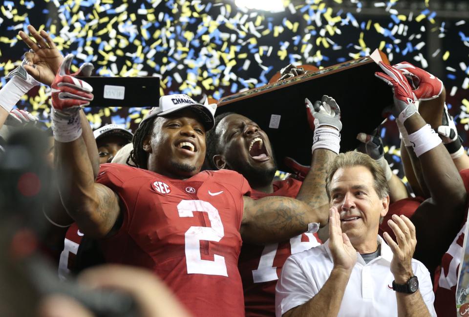 Alabama running back Derrick Henry (2) celebrates with coach Nick Saban following their win over the Florida Gators in the 2015 SEC Championship Game on Dec. 5, 2015 in Atlanta.