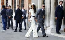 <p>Amal and George Clooney's civil ceremony in Venice turned quite a few heads thanks to the bride's navy and cream suit and sun hat by Stella McCartney.</p>