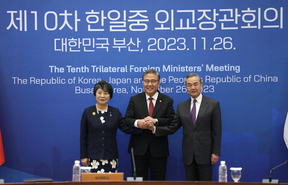 Chinese Foreign Minister Wang Yi, right, South Korean Foreign Minister Park Jin, center, and Japanese Foreign Minister Yoko Kamikawa pose for a photo prior to the trilateral foreign ministers' meeting in Busan, South Korea, Sunday, Nov. 26, 2023. (AP Photo/Ahn Young-joon, Pool)