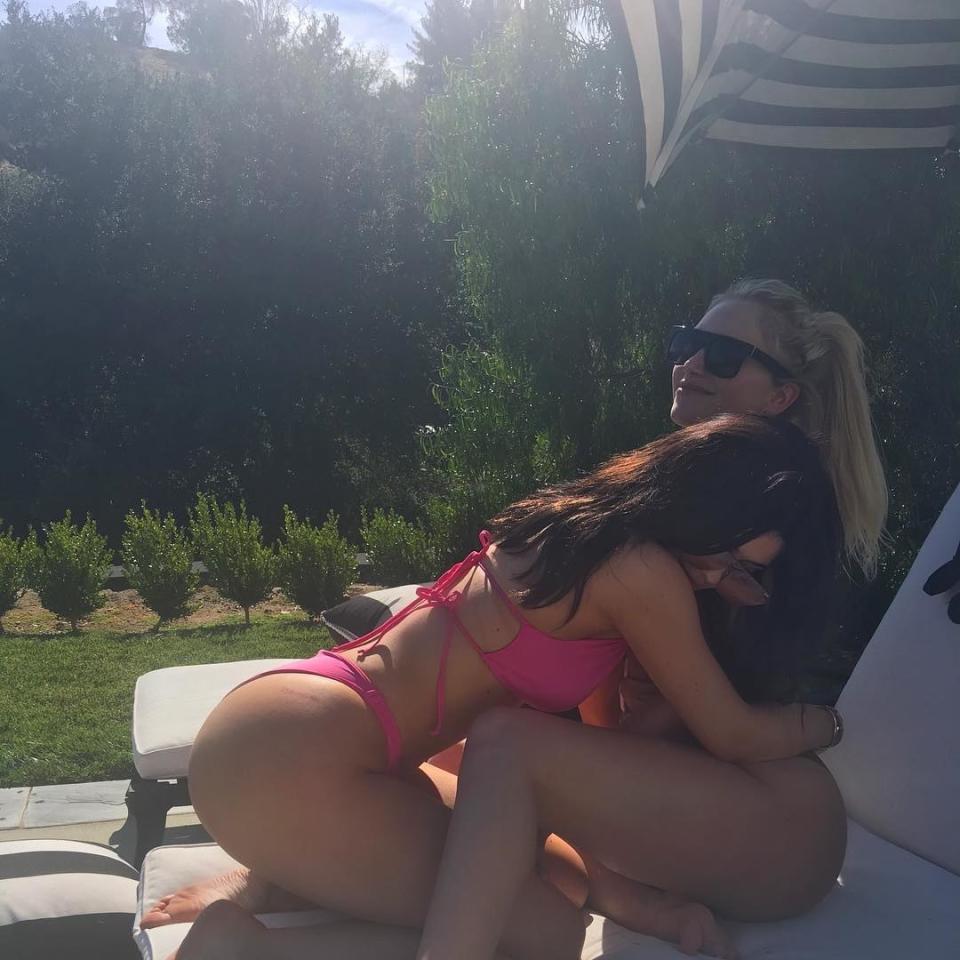 <p>It’s BFF time as Kylie embraces friend Anastasia Karanikolaou in a bright pink bikini.</p>