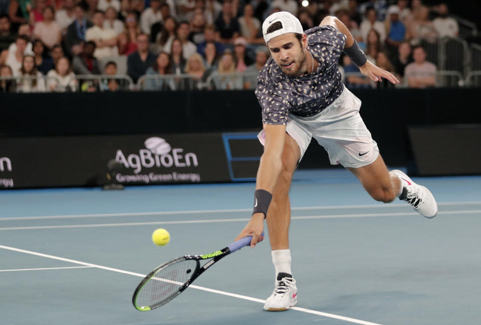 Russia's Karen Khachanov makes a backhand return to Australia's Nick Kyrgios during their third round singles match at the Australian Open tennis championship in Melbourne, Australia, Saturday, Jan. 25, 2020. (AP Photo/Lee Jin-man)