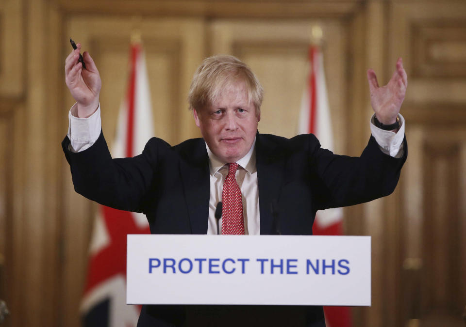 FILE - In this Sunday March 22, 2020 file photo British Prime Minister Boris Johnson gestures during his daily COVID 19 coronavirus press briefing to announce new measures to limit the spread of the virus, at Downing Street in London. The British prime minister's office says Boris Johnson will return to work Monday April 27, 2020, two weeks after he was discharged from a London hospital where he was treated for the new coronavirus. (Ian Vogler / Pool via AP, File)