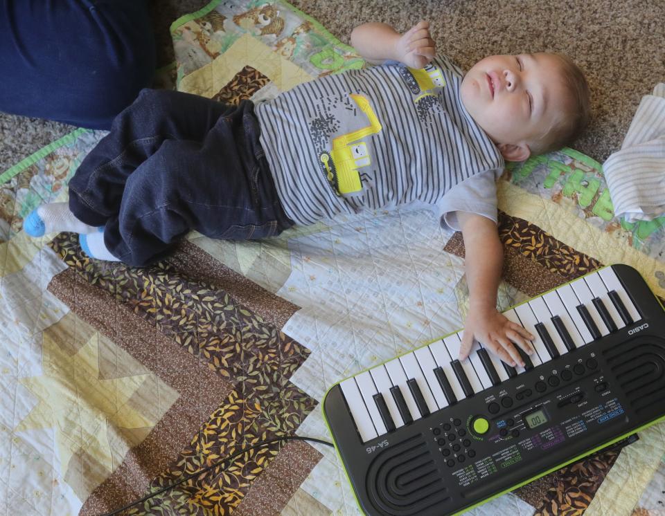 David Detwiler rests with his hand on the keyboard between therapy activities.