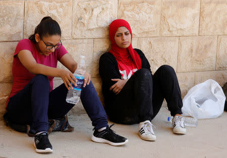 Egyptian women from Parkour Egypt "PKE" take a rest after playing around buildings on the outskirts of Cairo, Egypt July 20, 2018. REUTERS/Amr Abdallah Dalsh