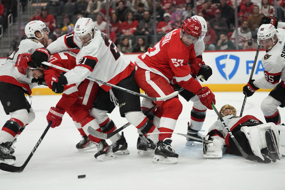 Ottawa Senators right wing Mathieu Joseph (21) hits Detroit Red Wings center Dylan Larkin (71) in the first period of an NHL hockey game Saturday, Dec. 9, 2023, in Detroit. (AP Photo/Paul Sancya)