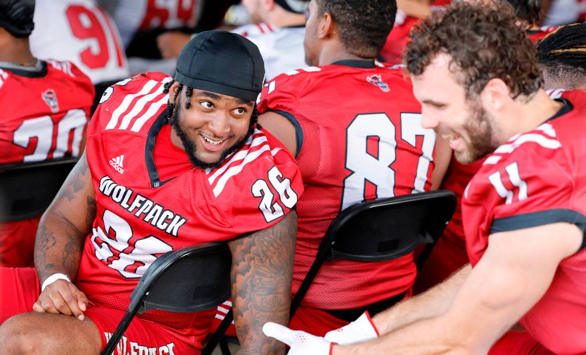 N.C. State linebacker Devon Betty (26) laughs with linebacker Payton Wilson (11) during a break during the Wolfpack’s first fall practice in Raleigh, N.C., Wednesday, August 2, 2023. Ethan Hyman/ehyman@newsobserver.com