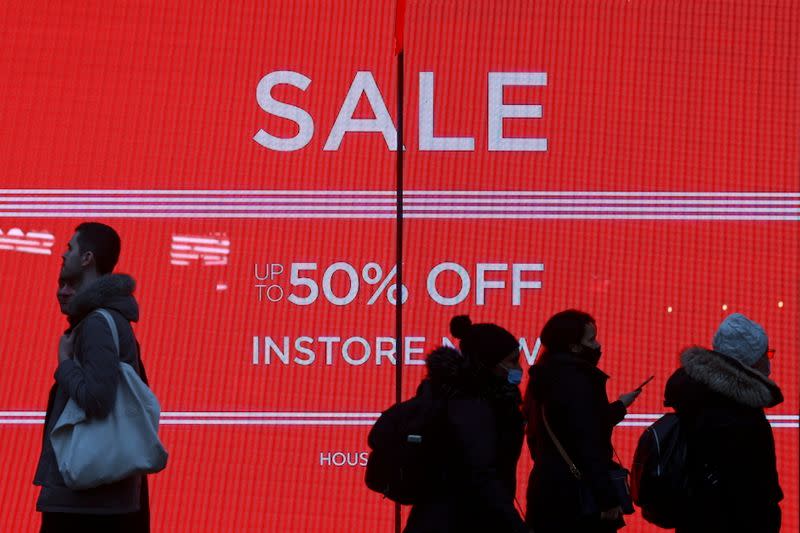 Shoppers walk down the street in London