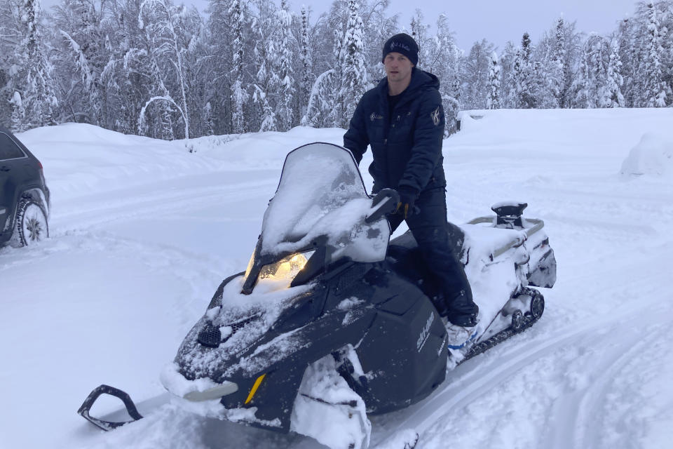 Five-time Iditarod champion Dallas Seavey is shown Feb. 22, 2022, arriving at his kennel in Talkeetna, Alaska, on a snowmobile. Seavey is tied with musher Rick Swenson for the most Iditarod victories ever, and Seavey is looking for his sixth title when the Iditarod Trail Sled Dog Race starts this weekend in Alaska. (AP Photo/Mark Thiessen)