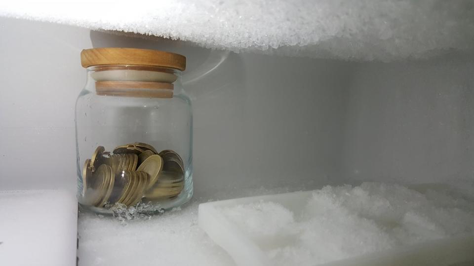 Glass jar of coins in the freezer