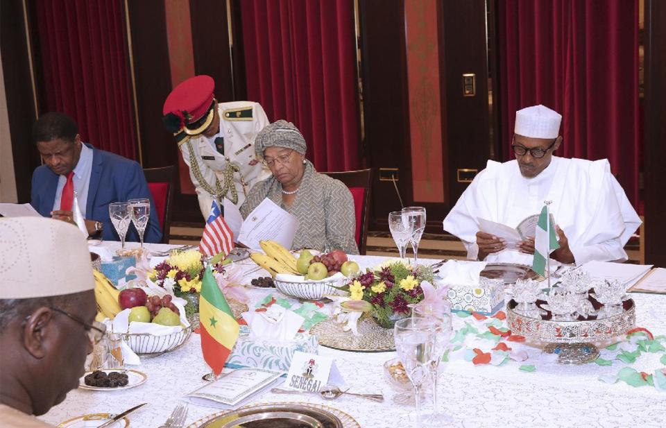 In this photo released by the Nigeria State House, Marcel de Souza, President of the Economic Community of West African States, left, Liberia President, Ellen Johnson Sirleaf, centre, Nigeria President Muhammadu Buhari, right, and Senegal President Macky Sall, foreground, during a meeting in Abuja, Nigeria, Monday, Jan. 9, 2017. Officials say Nigeria's President Muhammadu Buhari will lead three West African heads of state to Gambia on Wednesday in an effort to persuade its longtime leader to step down. (Sunday Aghaeze/Nigeria State House via AP)