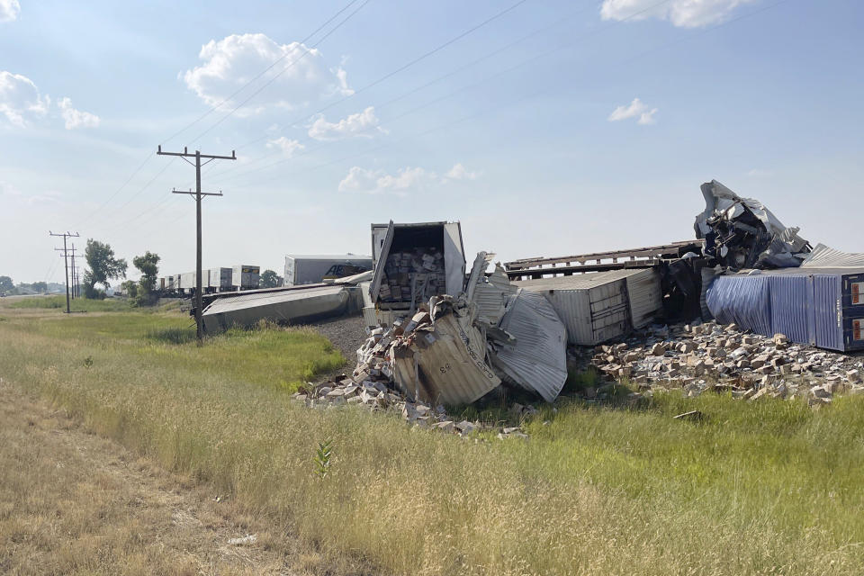 In this photo provided by Hill County Disaster and Emergency Services, freight cars from a BNSF Railway train are derailed east of Havre, Mont. on Friday, July 21, 2023. Local officials said 25 cars derailed but no one was injured. The cause is under investigation. (Amanda Frickel/Hill County Disaster and Emergency Services via AP)