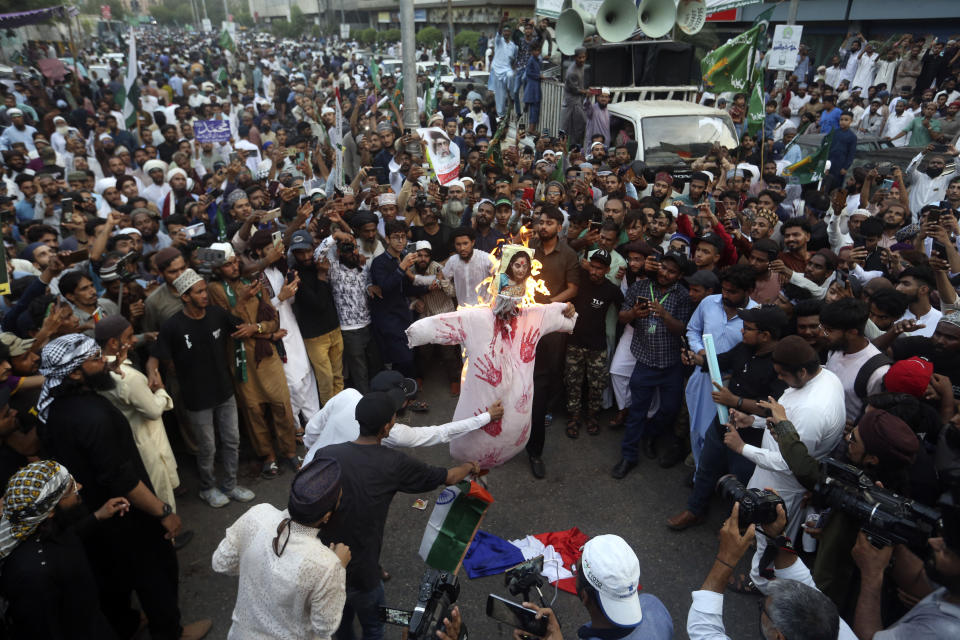 Supporters of a Pakistani religious group burn an effigy depicting former Bharatiya Janata Party spokeswoman Nupur Sharma during a demonstration to condemn derogatory references to Islam and the Prophet Muhammad recently made by Sharma, Friday, June 10, 2022, in Karachi, Pakistan. (AP Photo/Fareed Khan)