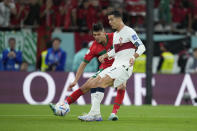 Portugal's Cristiano Ronaldo fights for the ball against Morocco's Achraf Hakimi during the World Cup quarterfinal soccer match between Morocco and Portugal, at Al Thumama Stadium in Doha, Qatar, Saturday, Dec. 10, 2022. (AP Photo/Ricardo Mazalan)