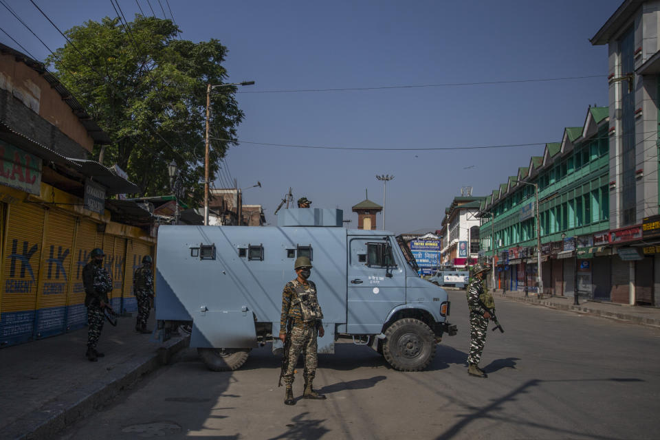 Paramilitary soldiers stand guard on a deserted street on the first anniversary of India’s decision to revoke the disputed region’s semi-autonomy, in Srinagar, Indian controlled Kashmir, Wednesday, Aug. 5, 2020. Last year on Aug. 5, India’s Hindu-nationalist-led government of Prime Minister Narendra Modi stripped Jammu-Kashmir of its statehood and divided it into two federally governed territories. Late Tuesday, authorities lifted a curfew in Srinagar but said restrictions on public movement, transport and commercial activities would continue because of the coronavirus pandemic. (AP Photo/ Dar Yasin)