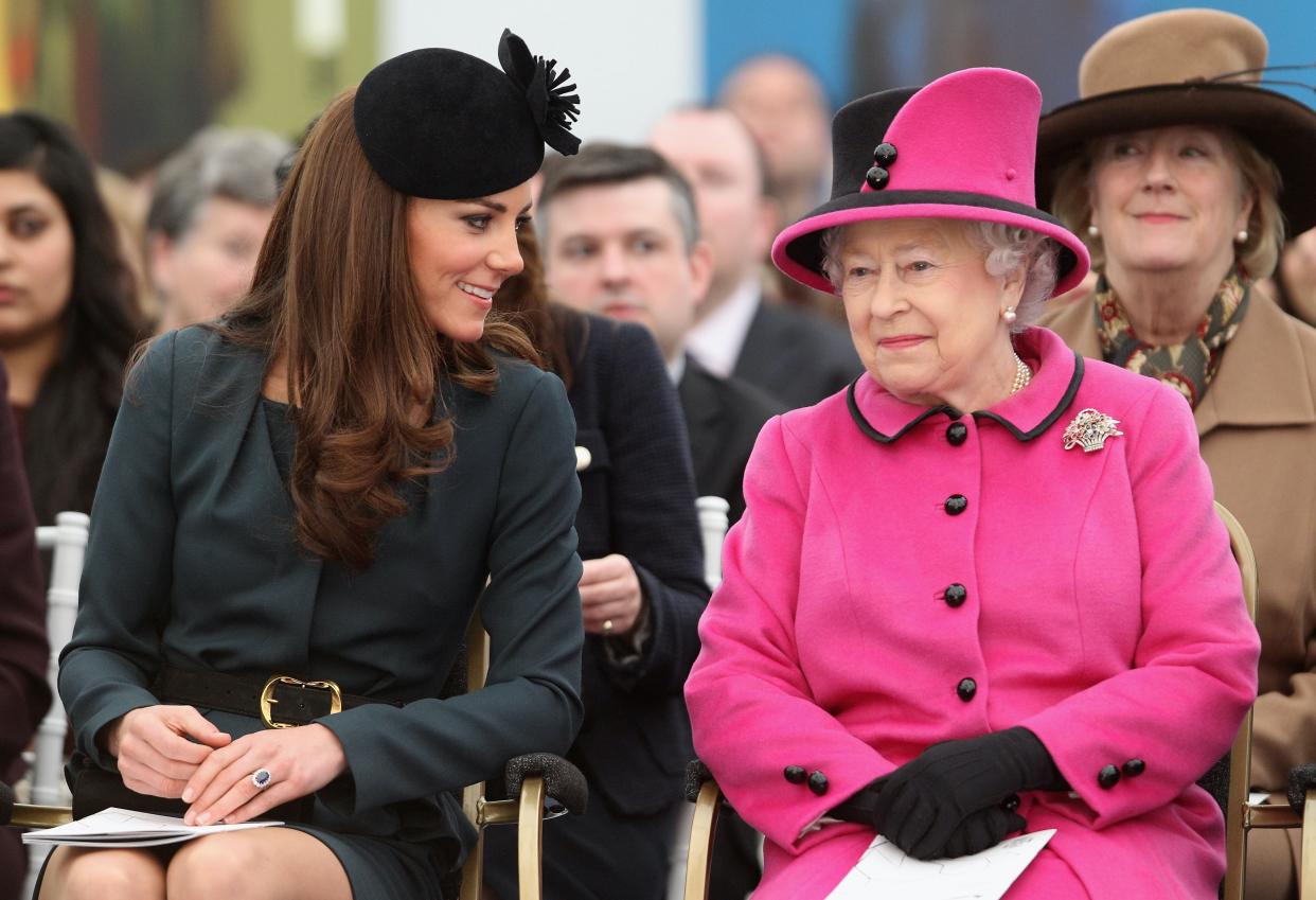  LEICESTER, ENGLAND - MARCH 08: Queen Elizabeth II (R) and Catherine, Duchess of Cambridge (L) watch a fashion show at De Montfort University on March 8, 2012 in Leicester, England. The royal visit to Leicester marks the first date of Queen Elizabeth II's Diamond Jubilee tour of the UK between March 8 and July 25, 2012. (Photo by Oli Scarff - WPA Pool / Getty Images). 