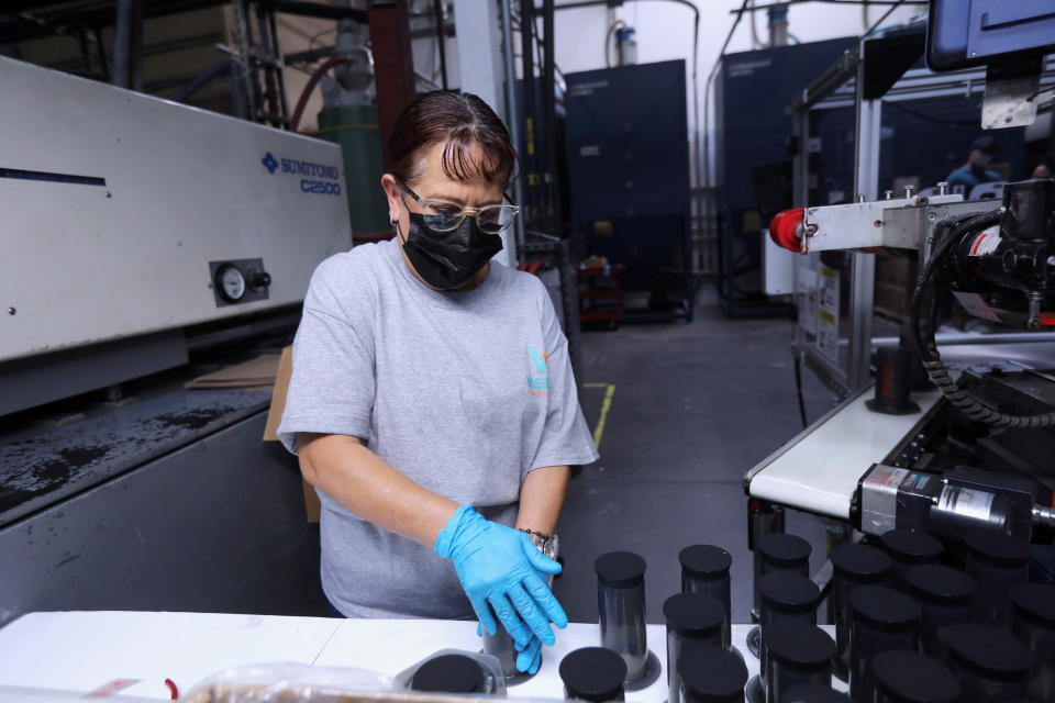 Worker Martha Escobar sorts products after they've been labeled with the help of a Rapid Robotics system at Westec Plastics Corp warehouse in Livermore, California, U.S. on August 19, 2021. Picture taken August 19, 2021. REUTERS/Nathan Frandino