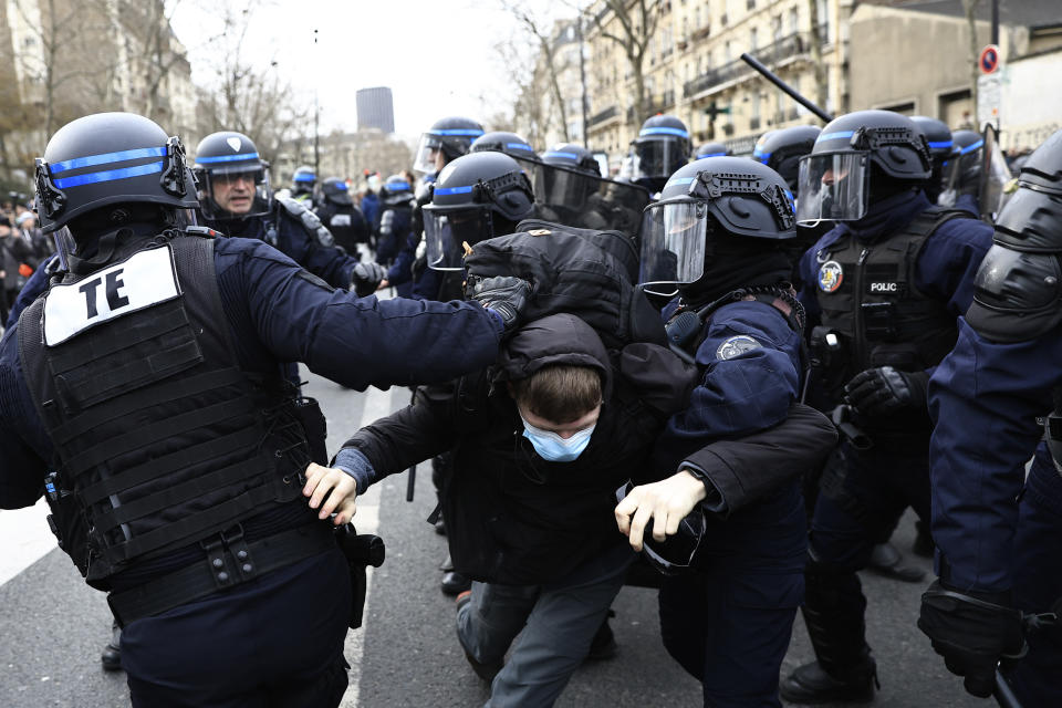 Police officers detain a protester during a demonstration in Paris, France, Wednesday, March 15, 2023. Opponents of French President Emmanuel Macron's pension plan are staging a new round of strikes and protests as a joint committee of senators and lower-house lawmakers examines the contested bill. (AP Photo/Aurelien Morissard)