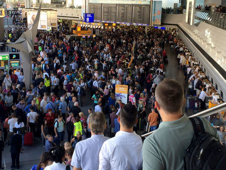 People gather at Frankfurt airport terminal after Terminal 1 departure hall was evacuated in Frankfurt, Germany, August 31, 2016. REUTERS/Andy Buerger