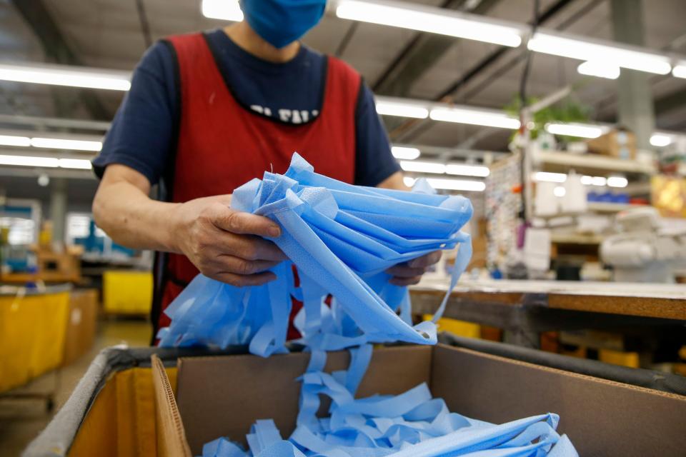 Completed face masks are packaged for shipping at the Tom Bihn factory in Seattle in March. Tom Bihn is a travel bag company that shifted production to face masks because of the COVID-19 outbreak.