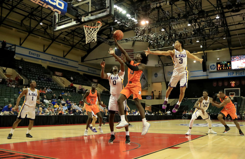 ORLANDO, FLORIDA - NOVEMBER 25: Isaac Likekele #13 of the Oklahoma State Cowboys drives past Tremont Waters #3 of the LSU Tigers during the game at HP Field House on November 25, 2018 in Orlando, Florida. (Photo by Sam Greenwood/Getty Images)